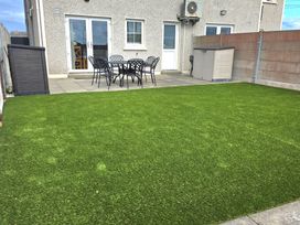 A garden with artificial grass and patio furniture at 63 Moinin, Kilkee, County Clare
