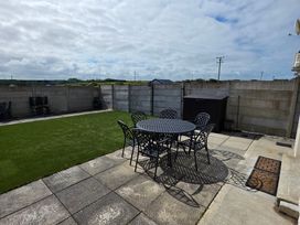 A garden with a table and chairs at 63 Moinin in Kilkee, County Clare