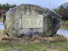 A large rock with an information panel at the Centre of Scotland