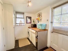A utility room with washing machine and countertop at Kilcarreg Rock near Wadebridge