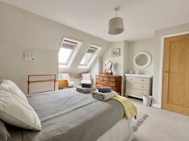 A bedroom with a bed and dresser at Kilcarreg in Rock near Wadebridge