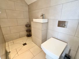A bathroom with a toilet and sink at Kilcarreg in Rock near Wadebridge