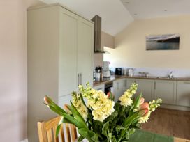 A kitchen with cabinets and appliances at Llaethdy - The Dairy Boncath near Crymych