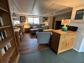 A living room with a sofa and dining table at 14 Boscaswell Downs Pendeen near St Just