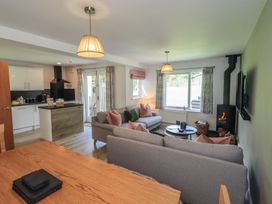 A living room with a sofa and coffee table at Yew - Woodland Cottages in Bowness-On-Windermere