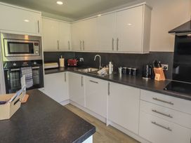 A kitchen featuring cabinets and appliances at Yew - Woodland Cottages Bowness-On-Windermere