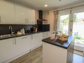 A kitchen with cabinets and a counter at Yew - Woodland Cottages in Bowness-On-Windermere