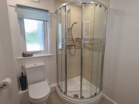 A bathroom with a shower and toilet at Yew - Woodland Cottages Bowness-On-Windermere