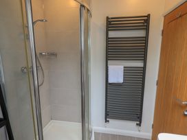 A bathroom featuring a shower and towel rail at Yew - Woodland Cottages in Bowness-On-Windermere