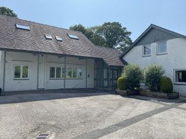 An exterior view of a house with a driveway at Hazel - Woodland Cottages Windermere