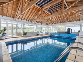 An indoor pool area with spa amenities at Chapel Green Studio Polgooth near St Austell