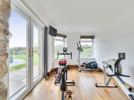 A gym with exercise equipment at Chapel Green Studio Polgooth near St Austell