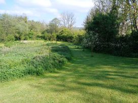A garden area with grass and trees at The Barn at Waunlippa Narberth