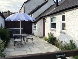 An outdoor sitting area with a table and chairs at The Barn at Waunlippa Narberth