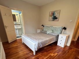 A bedroom with a bed and nightstands at The Sanctuary in Killavullen near Mallow