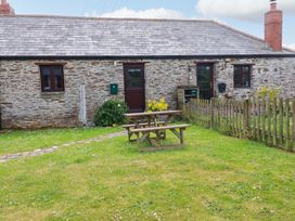 A cottage with a picnic table and garden at 4 Mowhay Cottages in Gorran Haven