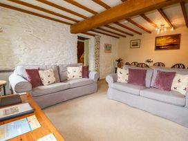 A living room with sofas and a dining area at 4 Mowhay Cottages Gorran Haven