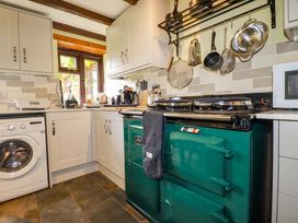 A kitchen with a washing machine and cooker at 4 Mowhay Cottages in Gorran Haven