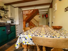 A kitchen with a dining table and chairs at 4 Mowhay Cottages Gorran Haven