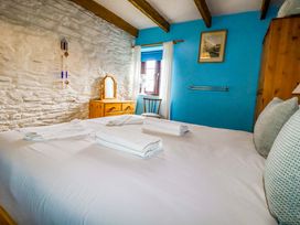 A bedroom with a bed and dresser at 4 Mowhay Cottages Gorran Haven