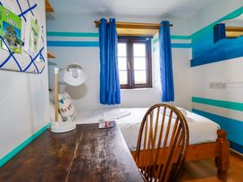 A bedroom with a bed and desk at 4 Mowhay Cottages Gorran Haven