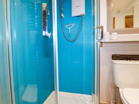 A bathroom with a shower and toilet at 4 Mowhay Cottages in Gorran Haven