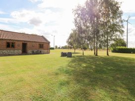 An outdoor area with a house and furniture at The Annexe in Litcham