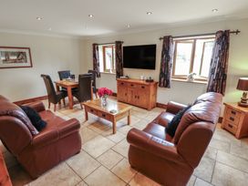 A living room with sofas and a dining area at The Annexe in Litcham
