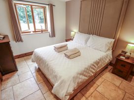 A bedroom with a bed, window, and bedside tables at The Annexe Litcham