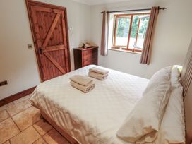 A bedroom with a bed and towels at The Annexe in Litcham