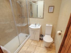 A bathroom with a shower, toilet, and sink at The Annexe Litcham