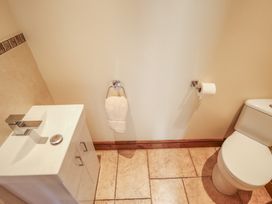 A bathroom with a sink and toilet at The Annexe in Litcham