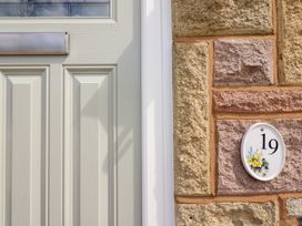 A door with a house number plaque at Chy Bean in Abergele