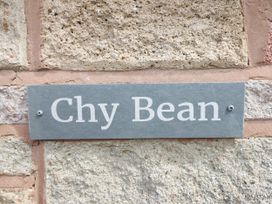 A plaque with the name Chy Bean on a stone wall in Abergele