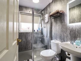 A bathroom with a shower, toilet, and sink at Chy Bean Abergele