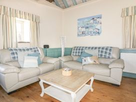 A living room with sofas and a coffee table at Dovecote in Gorran Haven