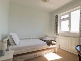 A bedroom with a single bed and a window at Treverrion in Gorran Haven
