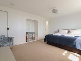 A bedroom with a bed and a desk at Treverrion in Gorran Haven