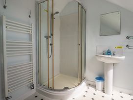 A bathroom with a shower and washbasin at Treverrion in Gorran Haven