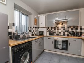 A kitchen with appliances and cabinetry at Fortunatus in Whitby