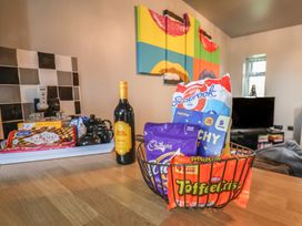 A kitchen with snacks and a bottle of wine at Fortunatus in Whitby