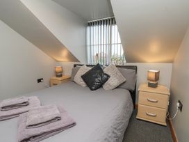 A bedroom with a bed and lamps at Fortunatus in Whitby