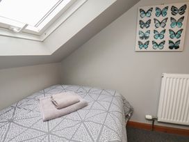 A bedroom with a bed and artwork at Fortunatus in Whitby