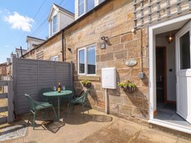 An outdoor seating area with a table and chairs at Fortunatus in Whitby