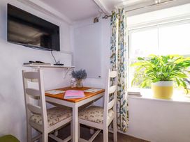 A dining area with a table and chairs at Longview Cottage Penwithick near St Austell