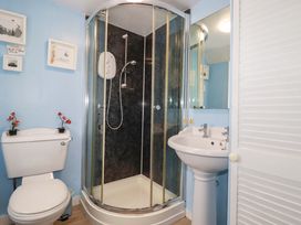 A bathroom with shower, sink, and toilet at Longview Cottage in Penwithick neat St Austell