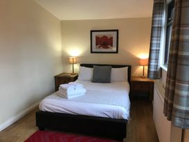 A bedroom with a bed and nightstand at Snowdrop in Saltburn-by-the-Sea