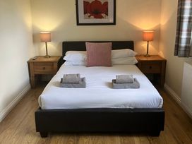 A bedroom with a bed and nightstands at Snowdrop in Saltburn-by-the-Sea