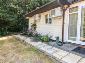A garden path with flowers along the side of a house at Badger View in Culverstone Green near Chatham
