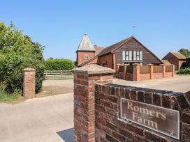 An outdoor view of a farm entrance with a brick wall and a house at Romers Farm Bockleton near Tenbury Wells